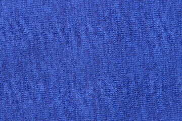 Bright royal blue knit fabric texture close-up. Vibrant solid color textile background for fashion, design, and upholstery concepts.