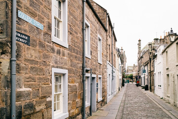 Obraz premium Quiet Cobblestone Street with Traditional Stone Buildings in Historic Town