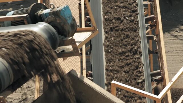 Rock crusher plant machine process, conveyor belts transport stones and dirt during the separation procedure, tilt up