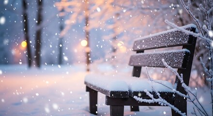 Empty park bench covered in snow during a winter snowfall