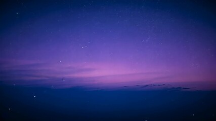 Deepening twilight causing sky showing violet gradient, stars drifting and specks above cloud bank - Powered by Adobe