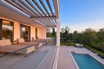 Modern luxury villa with pool, terrace, and minimalist architecture on a sunny day. Clean lines,...