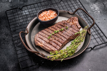 BBQ roasted beef Rump steak on steel tray. black background. top view