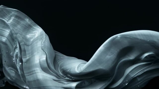 Revealing left edge, slate-gray ribbon flowing right across black void, exposing layered folds