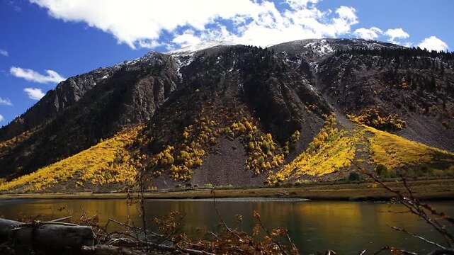 Autumn Mountain Scenery in Tibet Range with Golden Larches and Alpine Lake