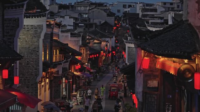 Ancient Chinese Town at Night with Traditional Architecture and Red Lanterns