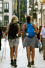 Camino de Santiago pilgrims in street of Bilbao city walking the Camino del Norte to Compostela , spanish route , Europe