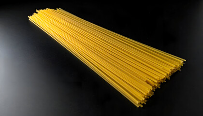 spaghetti strand isolated on black background, dramatic lighting, minimal food detail