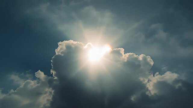Drifting cloud revealing sun disc in open sky, intensifying sun rays shining through gaps