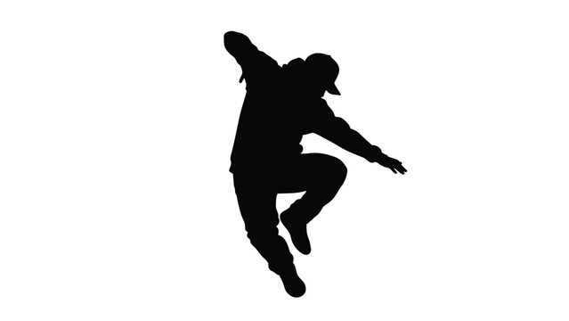 Silhouette of a young man breakdancing or performing hip hop dance moves in an energetic pose