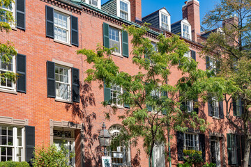 Naklejka premium The iconic red brick facades and black shutters of the historic townhouses defining the architecture of Beacon Hill, Boston.