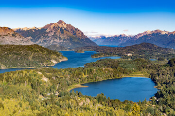 Impressive scenery from Cerro Campanario with a clear sight of Laguna El Trébol, Lake Moreno, and the Andean mountain range in Bariloche, Argentina.