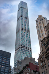 The immense vertical scale of the 432 Park Avenue luxury residential tower, contrasting with the surrounding classic architecture of Midtown Manhattam, New York City