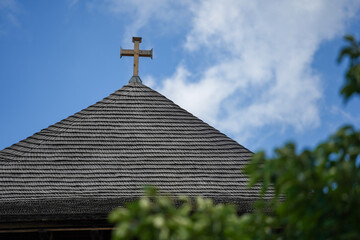the roof of an old church built of shingles.