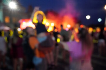 Blurred background. A city festival with people. Evening concert. A festive event. Crowd.