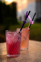 Colorful Cocktails in Glasses with Straws on the Table