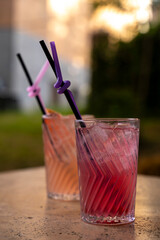 Colorful Cocktails in Glasses with Straws on the Table