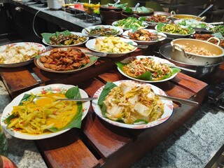 A vibrant and diverse buffet spread of traditional Southeast Asian cuisine