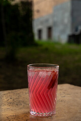 cocktail in a glass with a straw on a stone table.