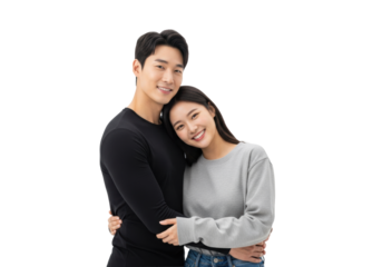 young east asian couple embracing, smiling confidently at camera. man in black shirt, woman in grey top and jeans, isolated on pure white studio background with copy space. concept of romantic