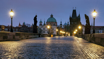 Charles Bridge over River Vltava at dramatic sunrise in Prague, Czech Republic, Europe