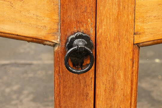 Handle on traditional brown wooden gates on drive to house, in the Victorian suburb of Morningside, Edinburgh, Scotland, UK