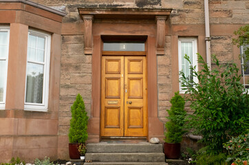 Traditional wooden front door in old stone house, in the Victorian suburb of Morningside, Edinburgh, Scotland, UK