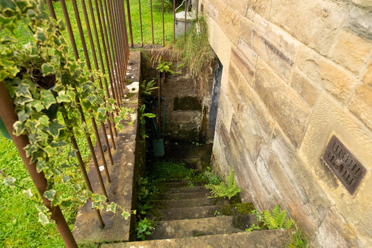 Damp stone steps down to basement outside old tenement building, in the Victorian suburb of Morningside, Edinburgh, Scotland, UK