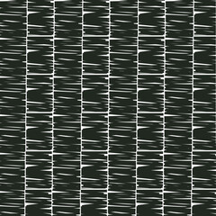 A dark, dense texture or surface composed of cut pieces, simulating a rug, plant cover, or patterned tiles.