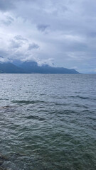 Cloudy Day Over a Serene Mountain Lake with Distant Shores, Switherland