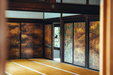 Traditional Japanese room with tatami mats and painted sliding doors