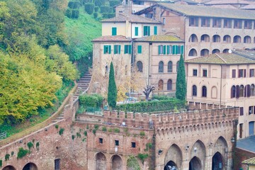 Obraz premium Siena, Italy – Historic brick architecture and hillside houses in Tuscany.