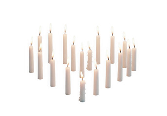 Burning candles arranged in heart shape