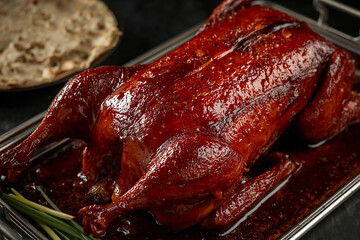 Peking duck with a crisp skin, served whole on a serving platter