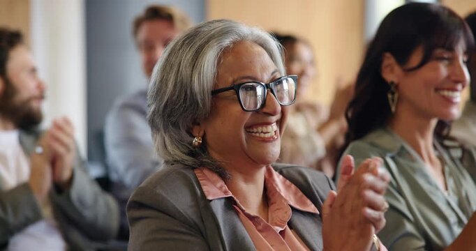 Applause, business and laughing with mature woman in conference room for seminar or workshop. Audience, development and support with excited people clapping in auditorium for presentation success