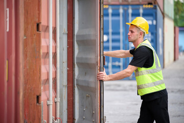 Worker is opening a shipping container and inspecting at the port