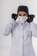 Beautiful woman wearing professional medical healthcare lab coat in studio photography