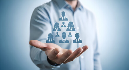 Businessman holding a glowing digital pyramid structure of diverse professional team members symbolizing human resources management and organizational hierarchy in a corporate setting
