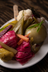 Pickled vegetables in a plate on a wooden table.
