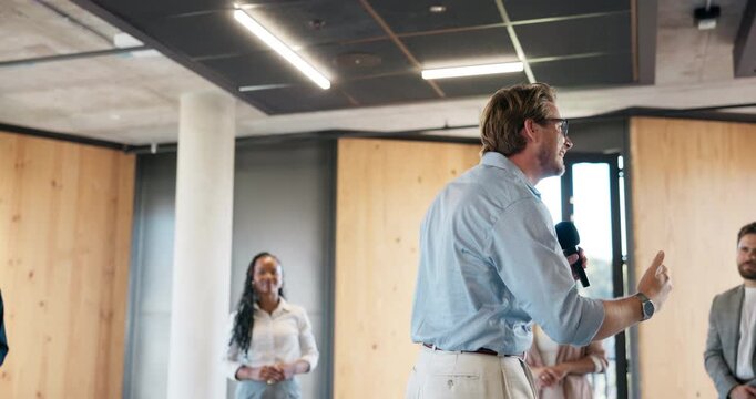 Business, inspiration and microphone with motivational speaker man in office for life coaching. Advice, crowd and speech with person in workplace for employee development, pep talk or support