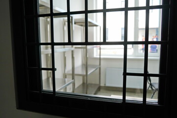 A grated window in the office for the collection and storage of things in the colony.