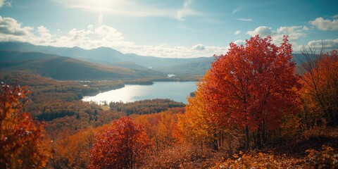 Fototapeta premium Fall scenery featuring a lake, trees with red and green leaves, and mountain backdrop in Ontario, seasonal transition