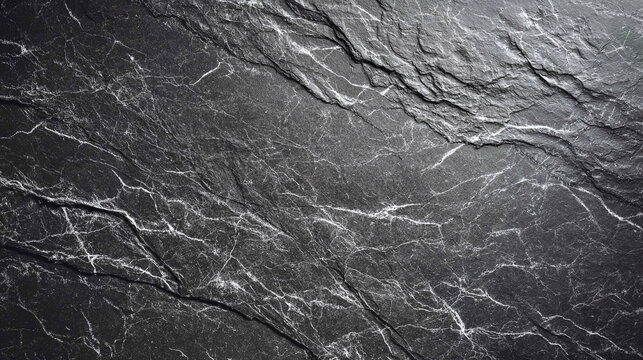 A dark gray stone texture with natural patterns. The stone surface has a rough and weathered appearance
