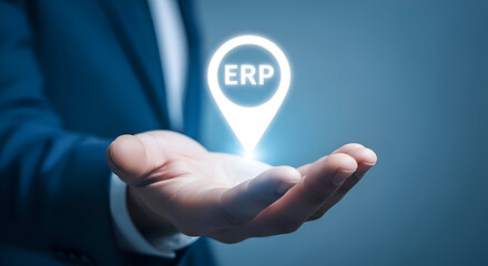 Businessman presents glowing digital map pin icon labeled erp floating above his open palm symbolizing centralized business resource planning and digital transformation strategy
