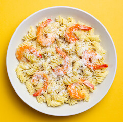 Pasta in a creamy sauce with shrimp and cheese. Italian cuisine.
