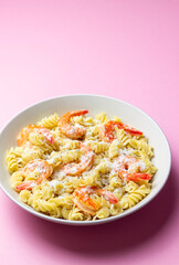 Pasta in a creamy sauce with shrimp and cheese. Italian cuisine.
