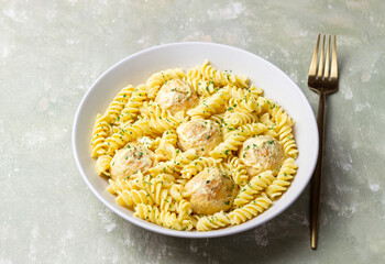 Pasta with chicken meatballs in a creamy sauce. Italian cuisine. Recipe.