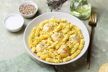 Pasta with chicken meatballs in a creamy sauce. Italian cuisine. Recipe.