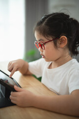 Young Child Using Tablet and Engaging with Digital Content