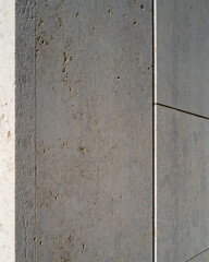 Concrete wall with textured surface and straight edges in natural light